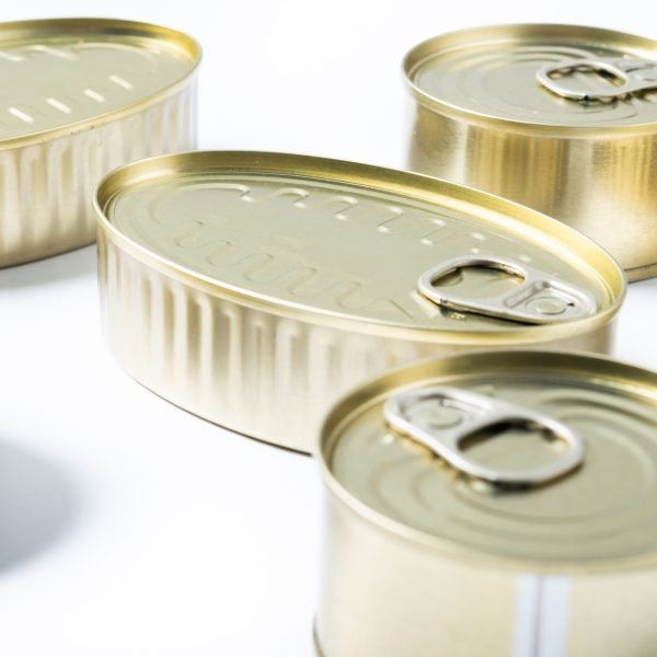 Various canned food in metal cans isolated on white background